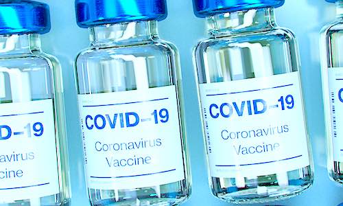 pfizer covid vaccine bottles on blue background