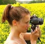 girl with camera yellow flowers