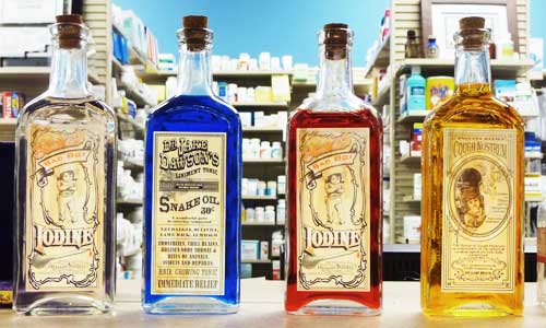 victorian medicine snake oil bottles on modern pharmacy counter