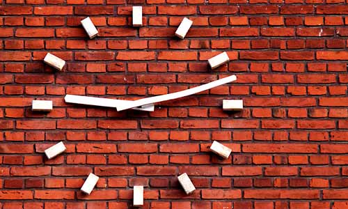 time restricted eating sugar white clock on brick wall