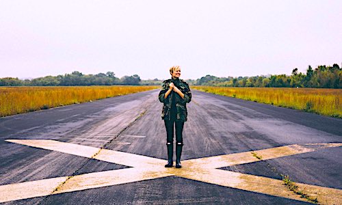 coronavirus infection rate woman standing on runway x